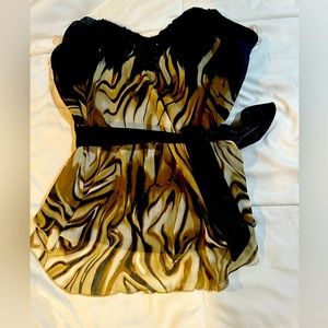 Small strapless top with sequins lining the bust snd a zippered back.